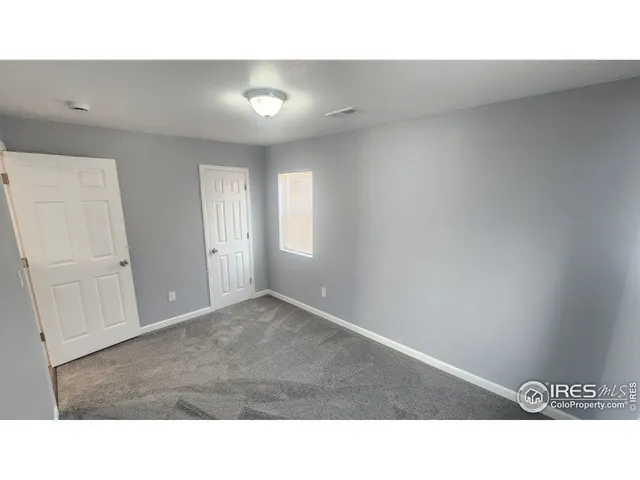 a bathroom with a toilet and a mirror