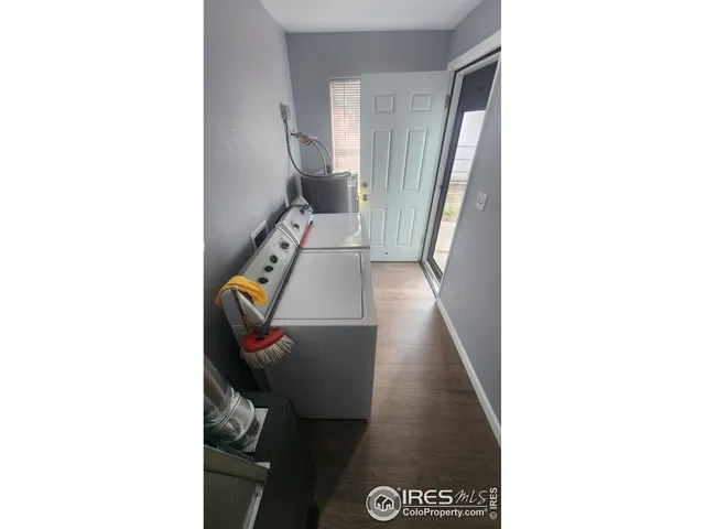 a view of living room with a chair and a potted plant