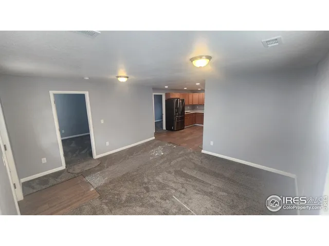 a kitchen with stainless steel appliances a refrigerator and a stove top oven