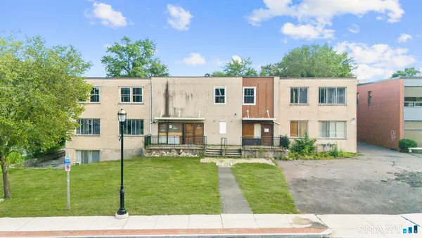 a view of house with a yard