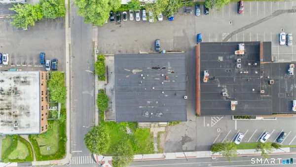 a aerial view of a house with a yard and a fountain