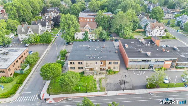 an aerial view of multiple houses with a yard