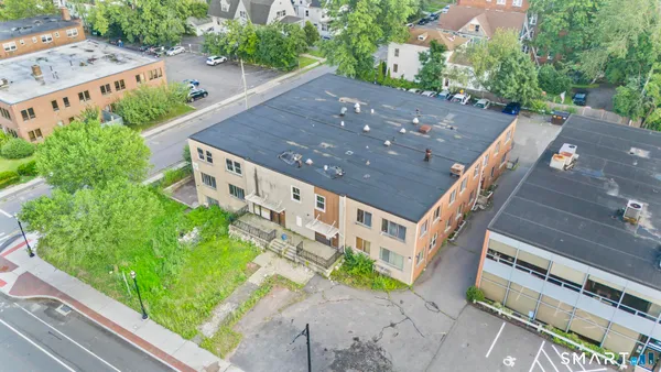 an aerial view of a house with garden space and sitting area
