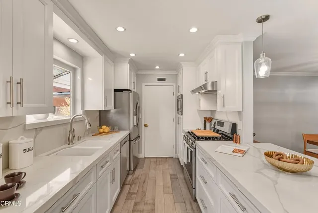 a kitchen with a sink stove and refrigerator