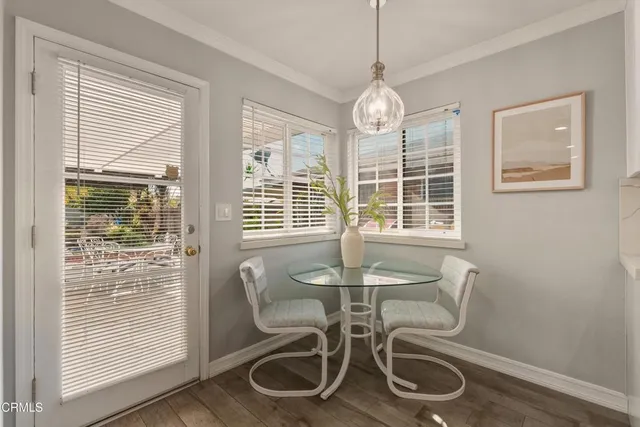 a view of a dining room with furniture windows and wooden floor