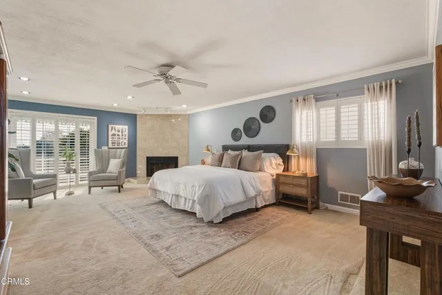 a bedroom with a large bed and windows