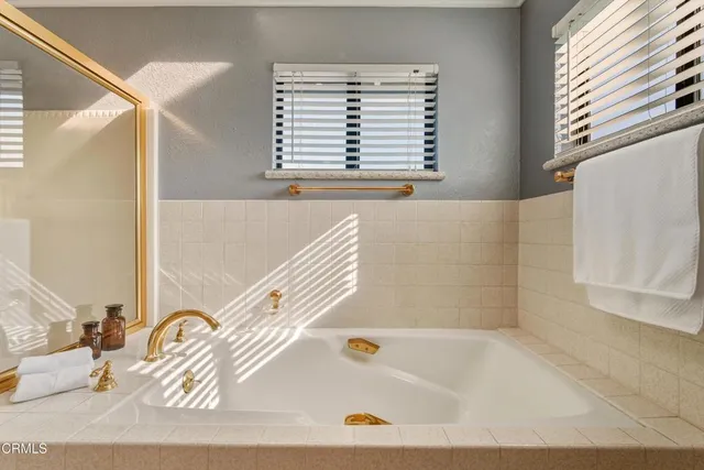 a bathroom with a bathtub and a window