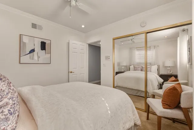 a bedroom with a bed and a painting on the wall