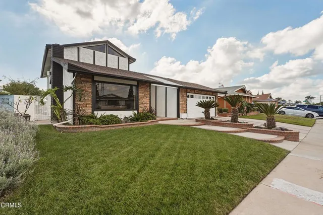 a view of a house with backyard porch and sitting area