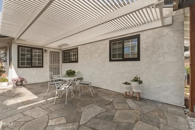 a patio with a table and chairs