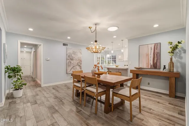 a dining room with furniture and wooden floor