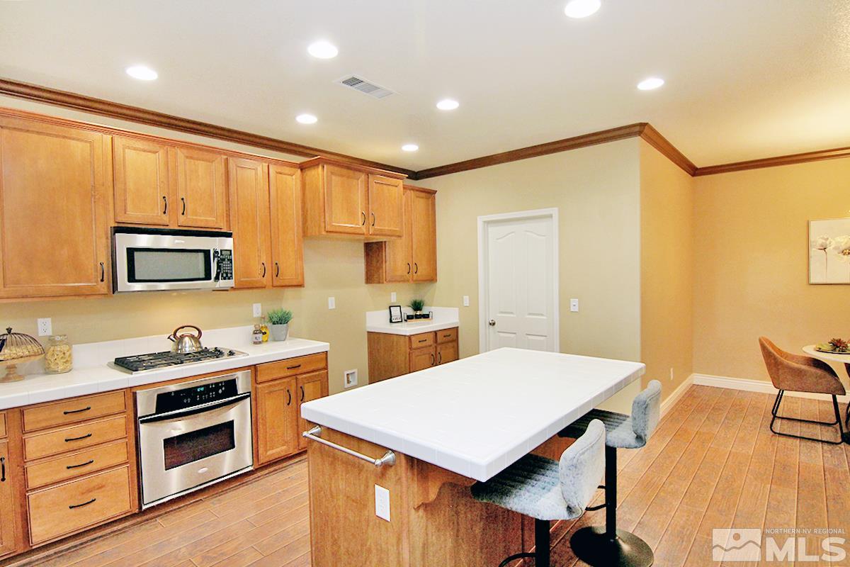 11205 Messina Way Reno, NV 89521 - Photo 11 of 40 a kitchen with a stove a sink and a refrigerator