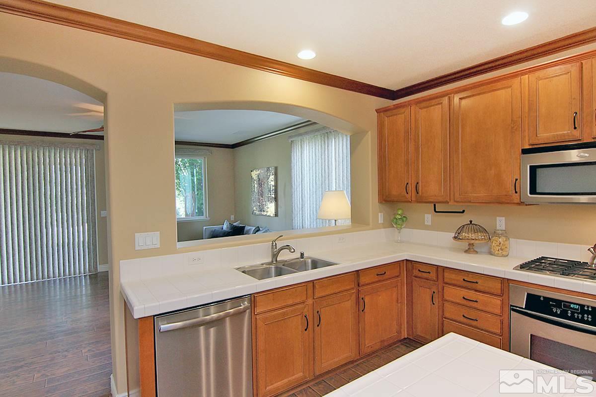 11205 Messina Way Reno, NV 89521 - Photo 12 of 40 a kitchen with a sink and cabinets