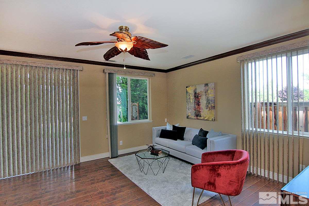 11205 Messina Way Reno, NV 89521 - Photo 17 of 40 a living room with furniture and wooden floor