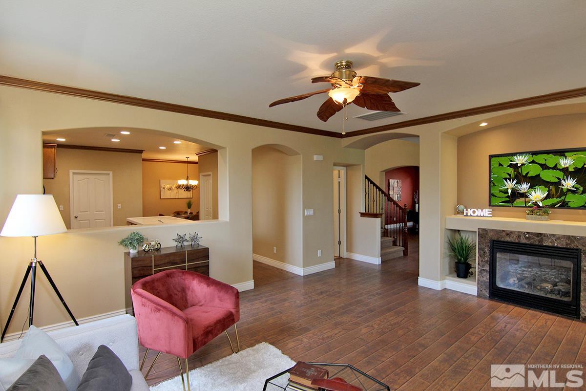 11205 Messina Way Reno, NV 89521 - Photo 20 of 40 a living room with furniture a flat screen tv and a fireplace