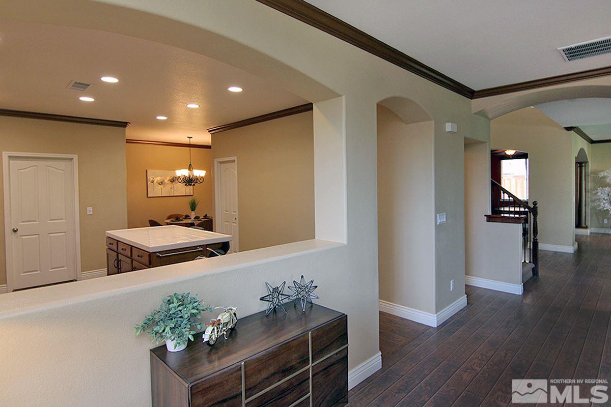 11205 Messina Way Reno, NV 89521 - Photo 21 of 40 a view of a hallway with wooden floor and furniture