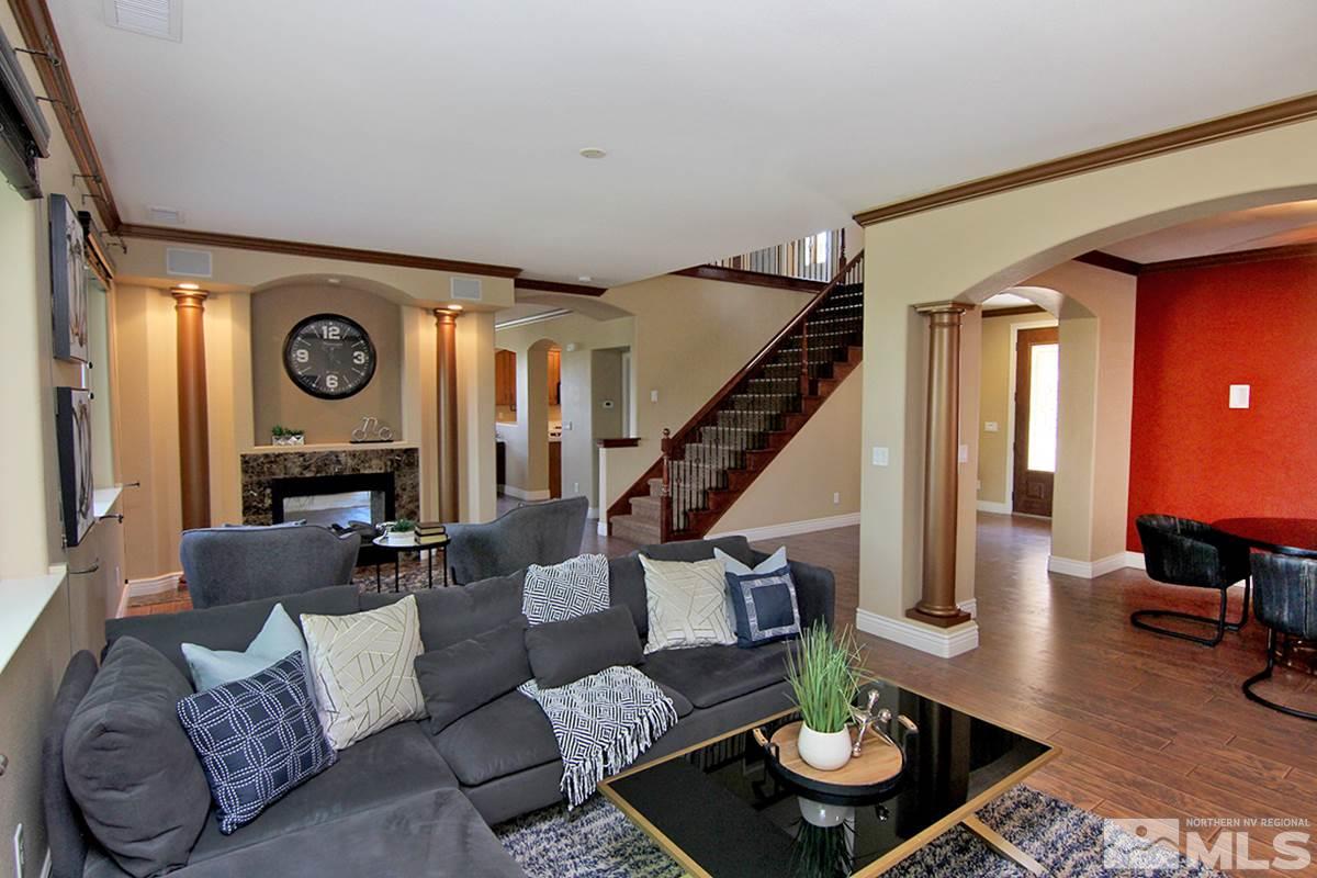 11205 Messina Way Reno, NV 89521 - Photo 3 of 40 a living room with furniture and a clock