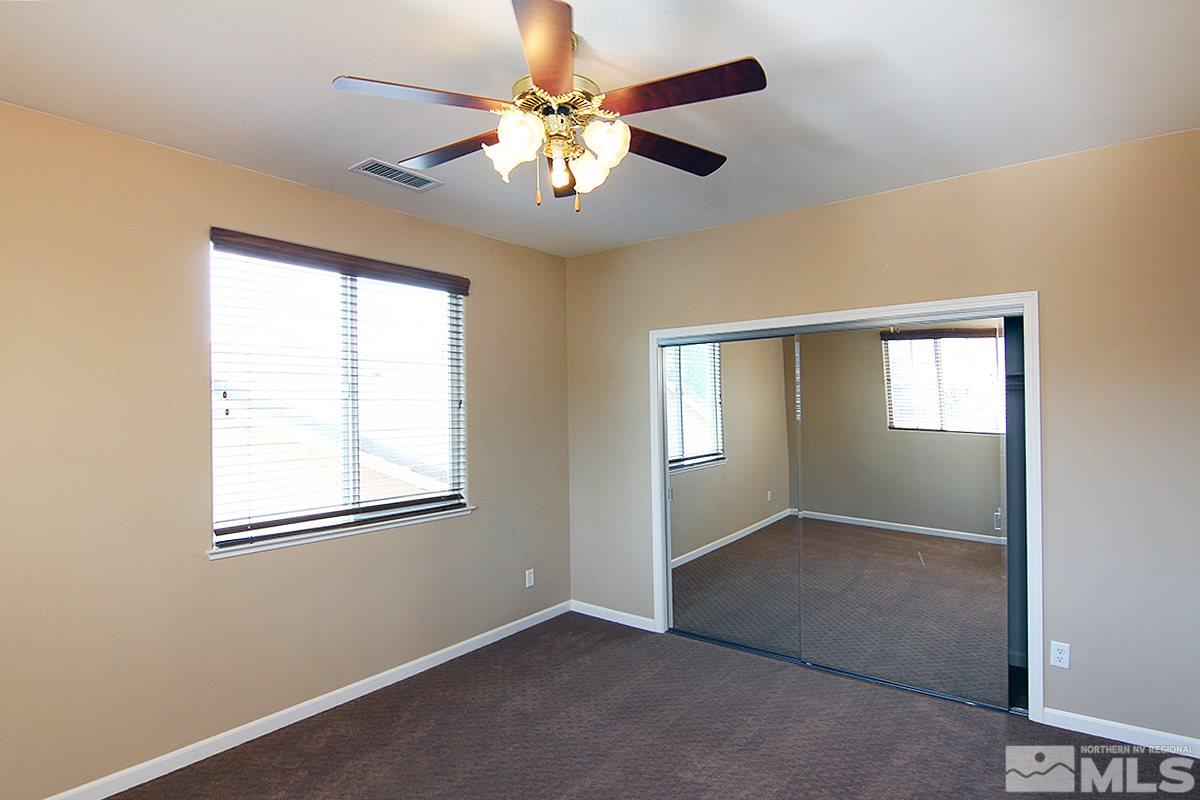 11205 Messina Way Reno, NV 89521 - Photo 32 of 40 an empty room with windows and fan