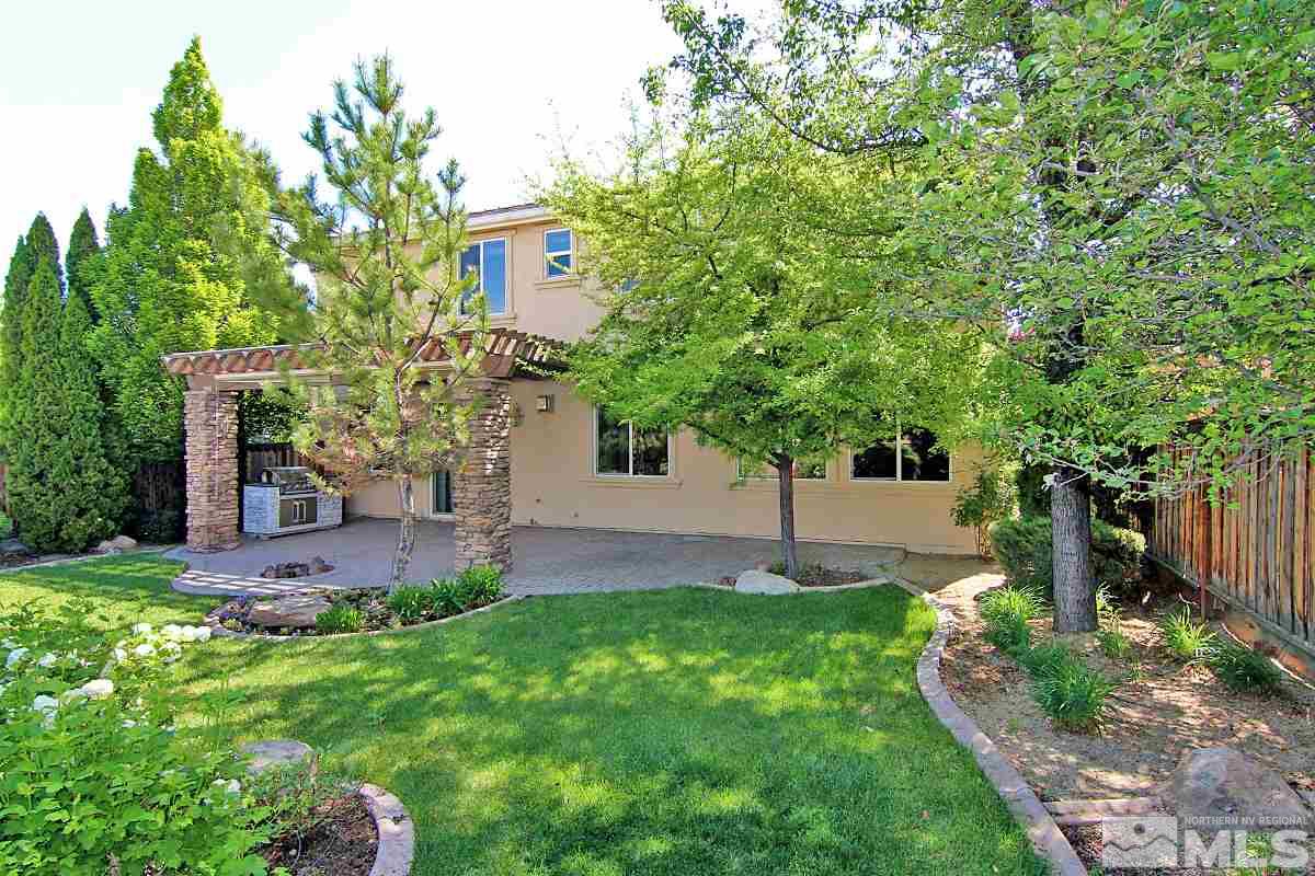 11205 Messina Way Reno, NV 89521 - Photo 34 of 40 a front view of a house with a yard and a tree