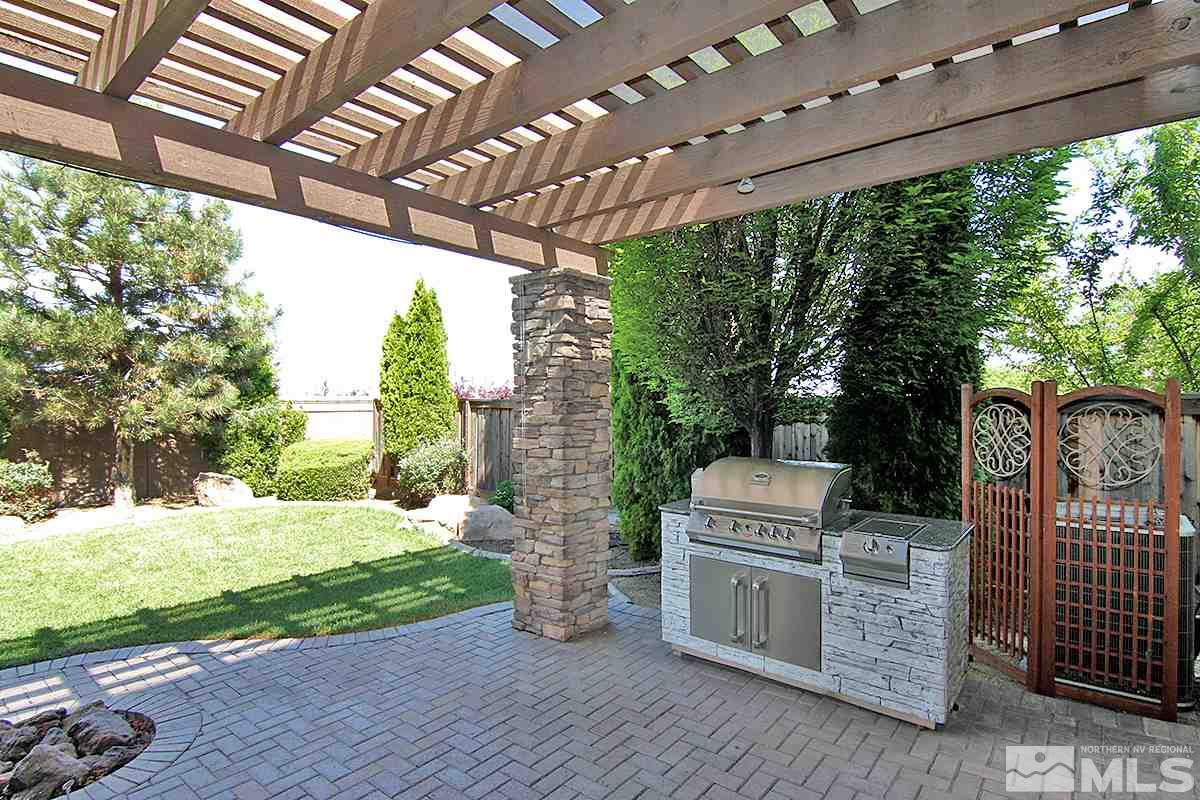 11205 Messina Way Reno, NV 89521 - Photo 39 of 40 a view of a porch with furniture and a yard