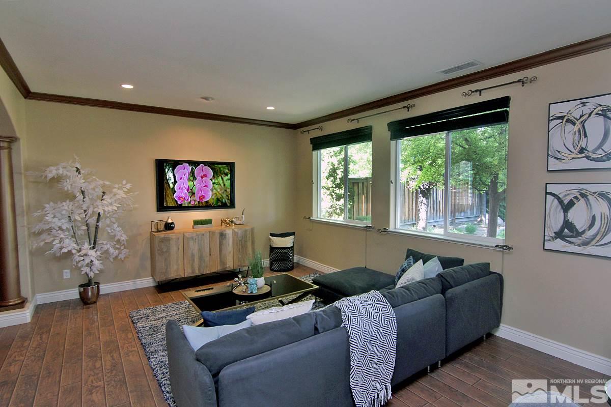 11205 Messina Way Reno, NV 89521 - Photo 4 of 40 a living room with furniture and a flat screen tv