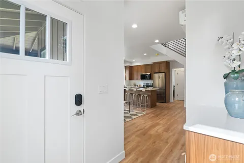 a open kitchen with white cabinets and stainless steel appliances