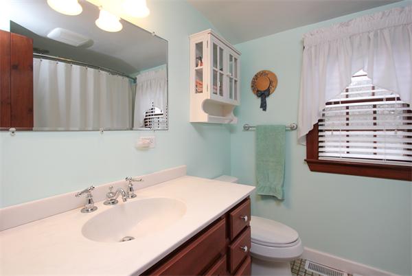 124 Miles River Road Hamilton, MA 01982 - Photo 14 of 22 a bathroom with a sink a toilet and mirror