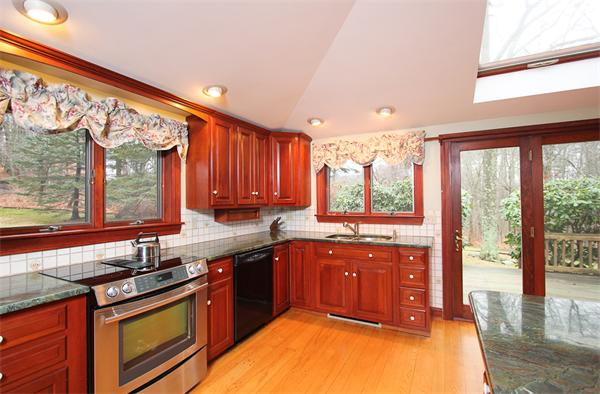 124 Miles River Road Hamilton, MA 01982 - Photo 2 of 22 a kitchen with a sink stove and cabinets