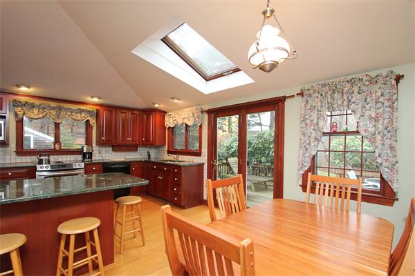 124 Miles River Road Hamilton, MA 01982 - Photo 3 of 22 a dining room with wooden floor a chandelier a wooden table and chairs