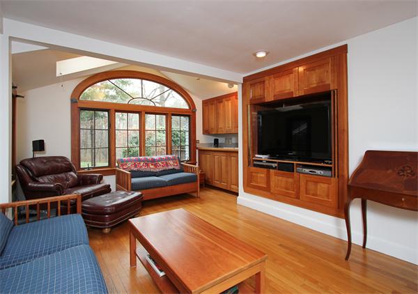 124 Miles River Road Hamilton, MA 01982 - Photo 7 of 22 a living room with furniture and a flat screen tv