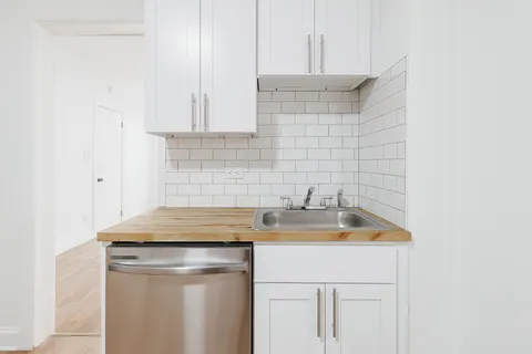 a kitchen with a sink and cabinets