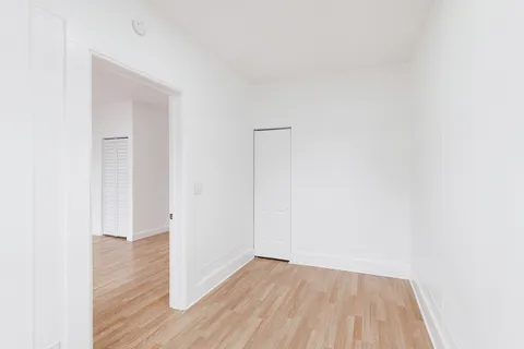 a view of a small space with wooden floor and a bathroom