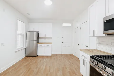 a kitchen with a stove and a refrigerator