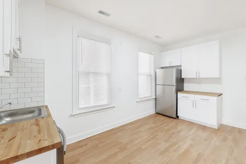 a view of a kitchen with a sink stove and a refrigerator