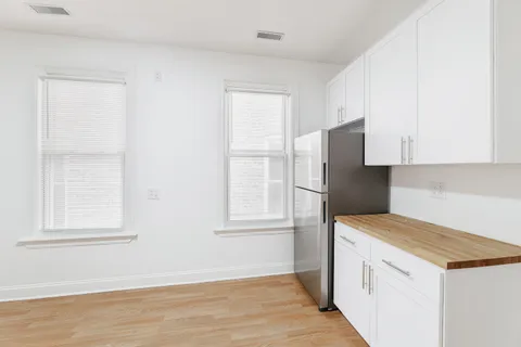 a kitchen with a refrigerator stove and cabinets