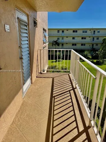 a view of a balcony with wooden floor