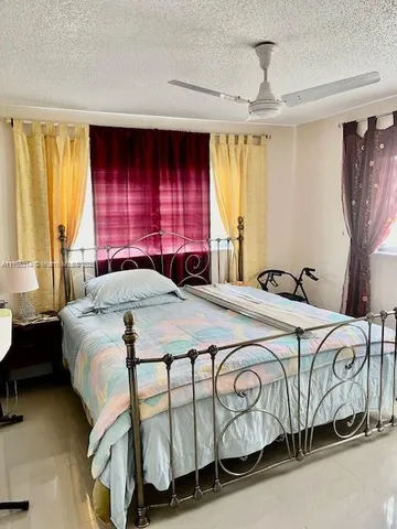 a spacious bedroom with a bed and window