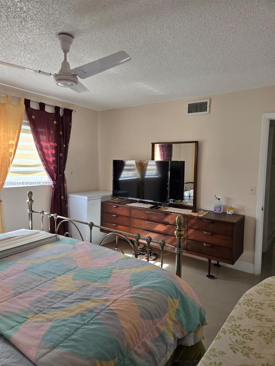 Boynton Beach Boynton Beach, FL 33435 - Photo 13 of 29 a bedroom with a bed and a chandelier