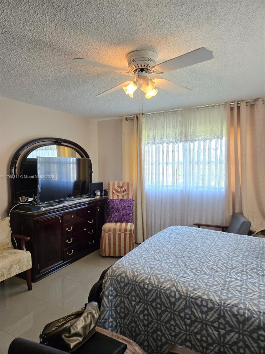 Boynton Beach Boynton Beach, FL 33435 - Photo 16 of 29 a bedroom with a bed and a chandelier