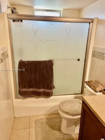 a kitchen with granite countertop a sink and cabinets