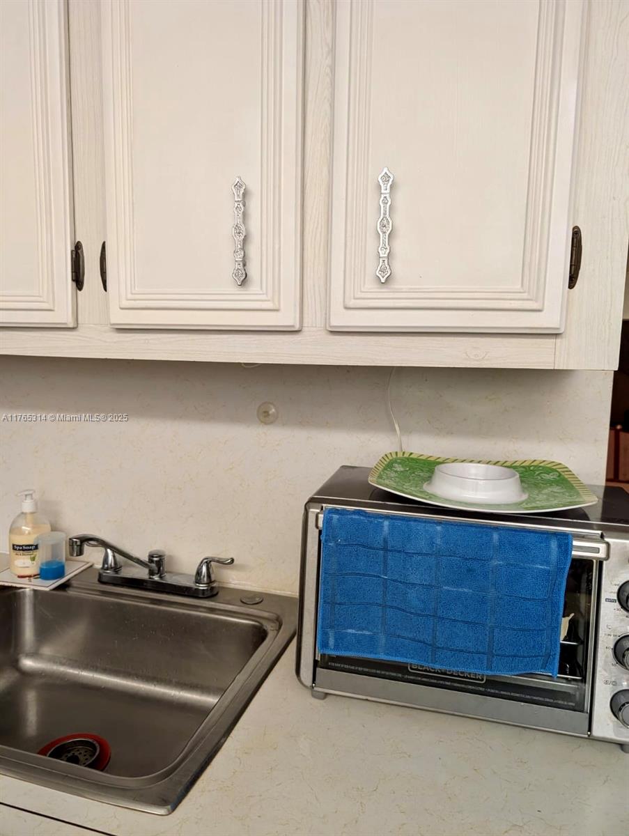 Boynton Beach Boynton Beach, FL 33435 - Photo 22 of 29 a kitchen with granite countertop a sink and cabinets