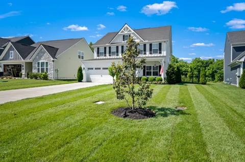 a front view of a house with a yard