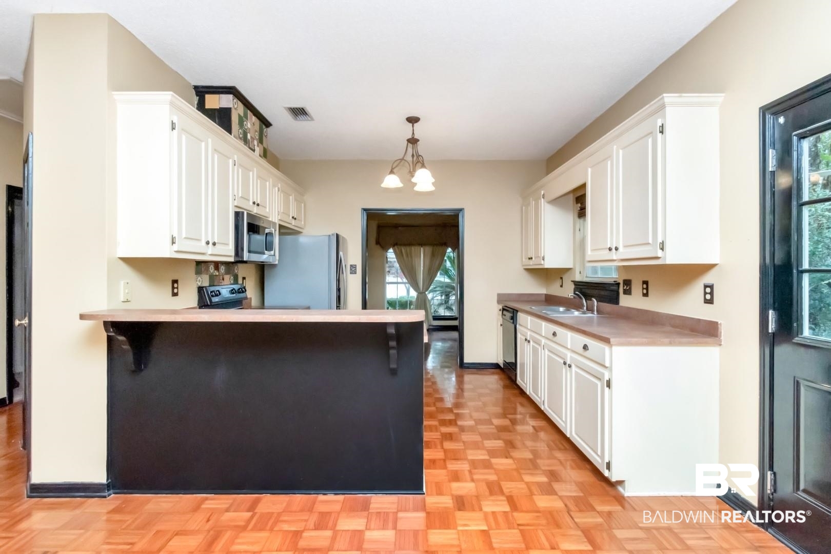 152 Ideal Avenue Mobile, AL 36608 - Photo 14 of 32 Kitchen with white cabinetry, plenty of natural light, pendant lighting, and appliances with stainless steel finishes
