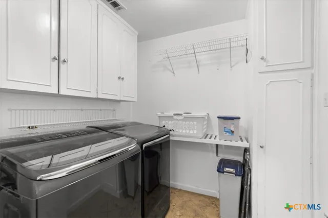 a kitchen with stainless steel appliances granite countertop a stove and a microwave oven