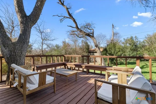 a view of a house with a big yard and large trees