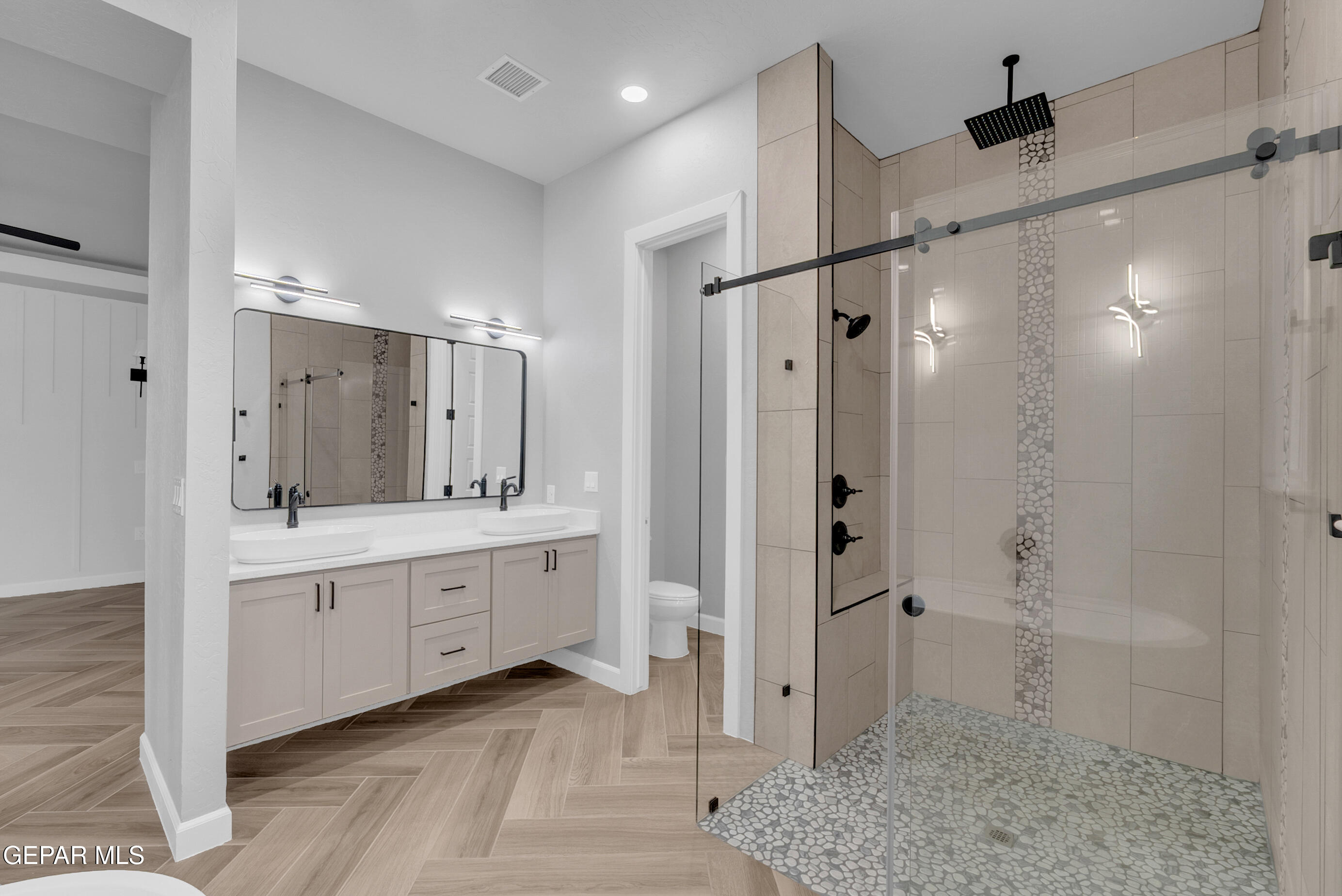 5612 Rio Bonito Circle El Paso, TX 79932 - Photo 60 of 79 a bathroom with a shower sink and mirror