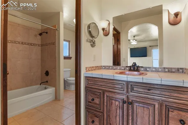 a bathroom with a double vanity sink mirror and bathtub