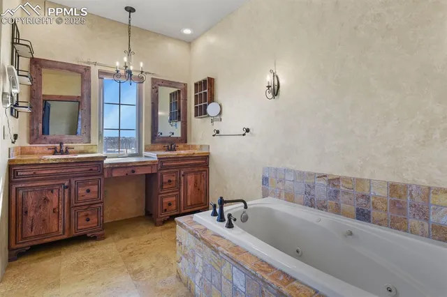 a bathroom with a tub a sink double vanity and a mirror