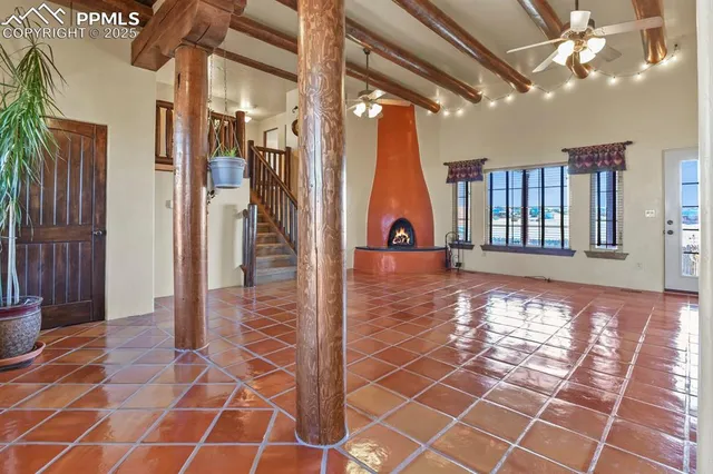 a view of a livingroom with wooden floor and furniture