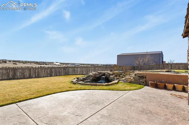 a view of a swimming pool and a yard